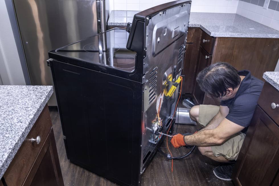 Technician servicing a washing machine