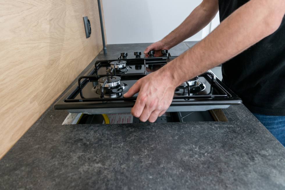 A man installing a stove 