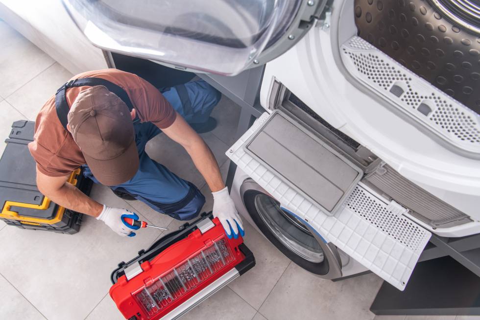 a person working on a washing machine